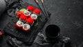 Sushi rolls - Red dragon with Tobiko caviar and salmon. Traditional Japanese cuisine. Royalty Free Stock Photo