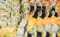 Sushi rolls with salmon, avocado, tuna and cucumber. Fresh maki with rice and nori. Delicious Japanese food with sushi roll in Royalty Free Stock Photo