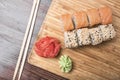 Sushi rolls with salmon and black and white sesame seeds, ginger, wasabi and sushi sticks Royalty Free Stock Photo