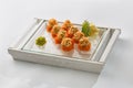 sushi rolls with salmon and red caviar on a plate isolated on white background Royalty Free Stock Photo