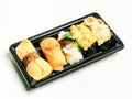 Sushi rolls set in plastic box isolated on white background. Royalty Free Stock Photo