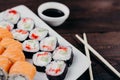 Sushi rolls set on plate with sauce and chopsticks Royalty Free Stock Photo