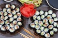 Sushi rolls set served on black stone plate on dark background. Flat lay, top view. Homemade japanese menu Royalty Free Stock Photo