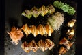 Sushi rolls set served on black stone slate on dark background Royalty Free Stock Photo