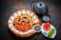 Sushi rolls set served on black stone slate on dark background. Japanese menu. Horizontal top view from above Royalty Free Stock Photo