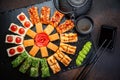 Sushi rolls set served on black stone slate on dark background. Japanese menu. Horizontal top view from above Royalty Free Stock Photo