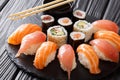 Sushi rolls set served on black stone slate on dark background Royalty Free Stock Photo