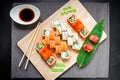 Sushi rolls set, soy sauce, ginger on bamboo leaf and chopsticks on a grey background. Top view. Flat lay. Japanese traditional fo Royalty Free Stock Photo