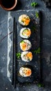 Sushi rolls on a slate plate with chopsticks Royalty Free Stock Photo