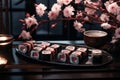 sushi rolls on a tray with cherry blossoms and candles Royalty Free Stock Photo