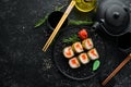 Sushi rolls with tuna and caviar. Sushi set on a black stone plate. Royalty Free Stock Photo