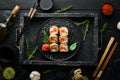 Sushi rolls with tuna and caviar. Sushi set on a black stone plate. Royalty Free Stock Photo