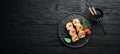 Sushi rolls with tuna and caviar. Sushi set on a black stone plate. Royalty Free Stock Photo