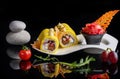 Sushi rolls on a white plate on a black background with reflection. Royalty Free Stock Photo