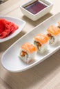 Sushi rolls in white plate with chopsticks and japanese spices Royalty Free Stock Photo
