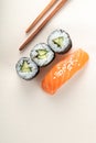 Sushi with salmon and cucumber roll with chopsticks Royalty Free Stock Photo