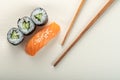 Sushi with salmon and cucumber roll with chopsticks Royalty Free Stock Photo