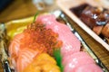 Sushi Salmon and others sushi are arranged in foam plant on the table ready to eat at Kuromon Fish Market, Osaka, Japan Royalty Free Stock Photo