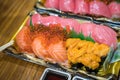 Sushi Salmon and others sushi are arranged in foam plant on the table ready to eat at Kuromon Fish Market, Osaka, Japan Royalty Free Stock Photo