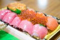 Sushi Salmon and others sushi are arranged in foam plant on the table ready to eat at Kuromon Fish Market, Osaka, Japan Royalty Free Stock Photo