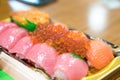 Sushi Salmon and others sushi are arranged in foam plant on the table ready to eat at Kuromon Fish Market, Osaka, Japan Royalty Free Stock Photo