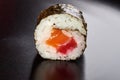 sushi with salmon and rice one piece close-up black background