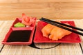 Sushi with salmon, soy sauce, ginger, wasabi on mat Royalty Free Stock Photo