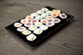 Sushi and Sashimi rolls on a wooden table. Fresh made Sushi set with salmon, prawns, wasabi and ginger. Traditional Japanese cuisi Royalty Free Stock Photo