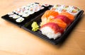Sushi and Sashimi rolls on a wooden table. Fresh made Sushi set with salmon, prawns, wasabi and ginger. Traditional Japanese cuisi Royalty Free Stock Photo