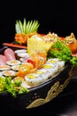 Sushi sashimi set in a wooden boat on a brown Royalty Free Stock Photo