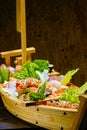 Sushi sashimi set in a wooden boat on a brown Royalty Free Stock Photo