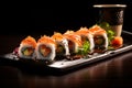 Sushi set on a black background. Sushi rolls with salmon, avocado, cucumber, cream cheese and sauce