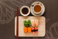 Sushi set with chop sticks and soy sauce served on wooden slate Royalty Free Stock Photo