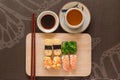 Sushi set with chop sticks and soy sauce served on wooden slate Royalty Free Stock Photo