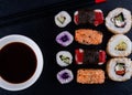 sushi set with chopsticks and soy on black plate ready to eat on black background Royalty Free Stock Photo