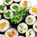 Sushi Set. Different types of sushi rolls and sashimi with seaweed in center. Asian or Japanese food, Oriental cuisine Royalty Free Stock Photo