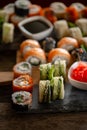 Sushi set food photo. Rolls served on brown wooden and slate plate. Close up of sushi Royalty Free Stock Photo