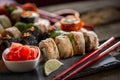 Sushi set food photo. Rolls served on brown wooden and slate plate. Close up of sushi Royalty Free Stock Photo