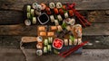 Sushi set food photo. Rolls served on brown wooden and slate plate. Close up and top view of sushi. 16 in 9 crop Royalty Free Stock Photo