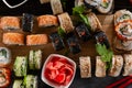 Sushi set food photo. Rolls served on brown wooden and slate plate. Close up view of pickled ginger Royalty Free Stock Photo