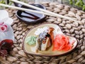 Sushi Set nigiri and sushi rolls decorated with flowers on bamboo background. Japanese cuisine. Selective focus. Royalty Free Stock Photo