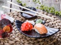 Sushi Set nigiri and sushi rolls decorated with flowers on bamboo background. Japanese cuisine. Royalty Free Stock Photo