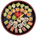 Sushi Set nigiri, rolls and sashimi served in traditional Japan black Sushioke round plate. On white background Royalty Free Stock Photo