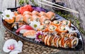 Sushi Set nigiri and sushi rolls decorated with flowers on bamboo background. Royalty Free Stock Photo