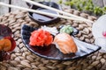 Sushi Set nigiri and sushi rolls decorated with flowers on bamboo background. Japanese cuisine. Royalty Free Stock Photo