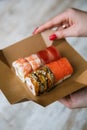 sushi set on packing box in hand Royalty Free Stock Photo