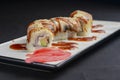 Sushi set, sushi rolls with cream cheese and eel served on a white plate over black background Royalty Free Stock Photo