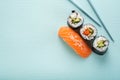 Sushi set with salmon nigiri and roll with cucumber and vegetables with chopsticks Royalty Free Stock Photo