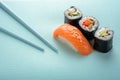 Sushi set with salmon nigiri and roll with cucumber and vegetables with chopsticks Royalty Free Stock Photo