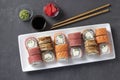 Sushi set with salmon, tuna and smoked eel with philadelphia cheese on white plate on gray background. Served with soy sauce, Royalty Free Stock Photo
